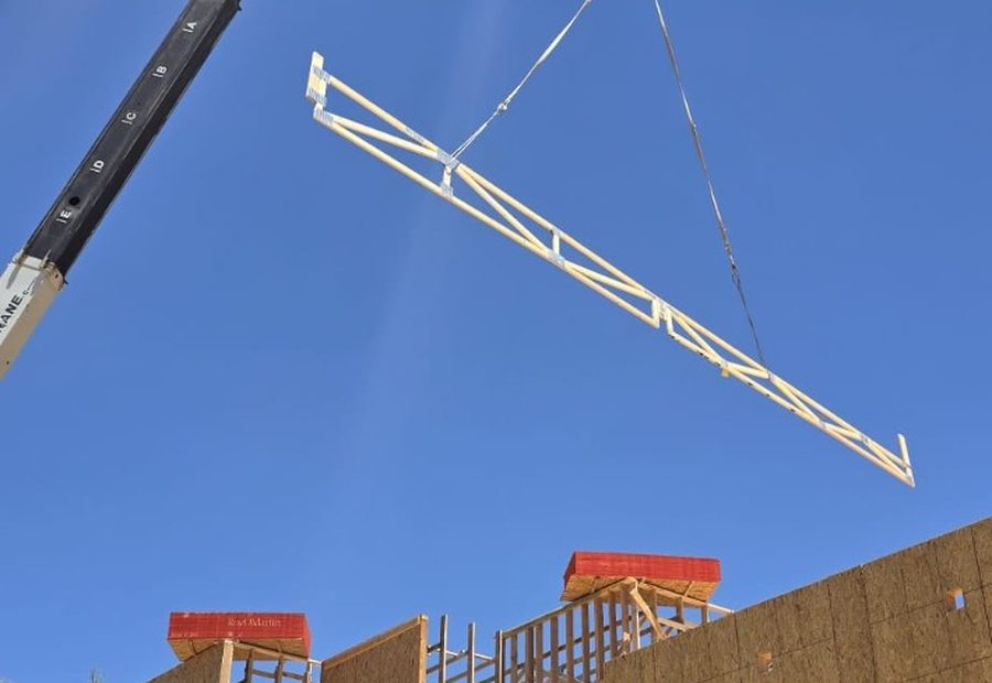 Crane setting roof trusses